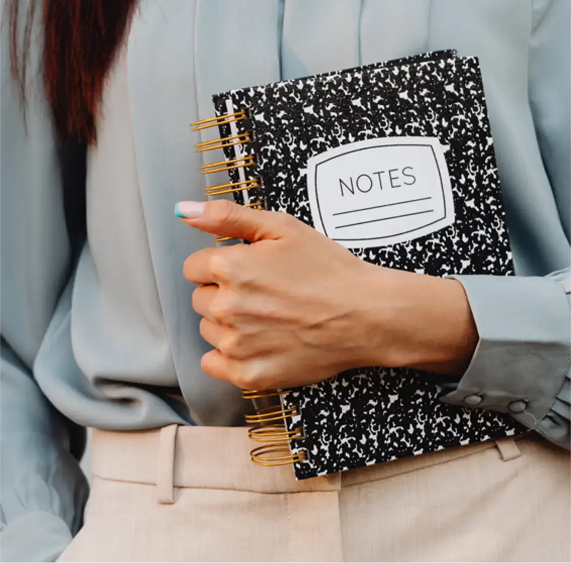professional woman holding a notebook